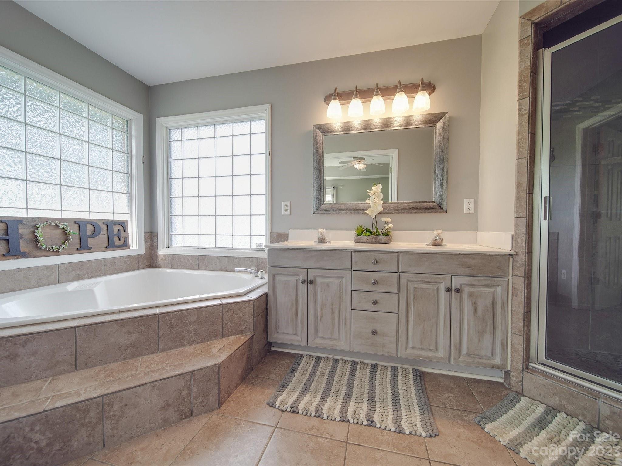 5817 Unionville Road Monroe, NC 28110 - Photo 39 of 46 a spacious bathroom with a tub sink and mirror