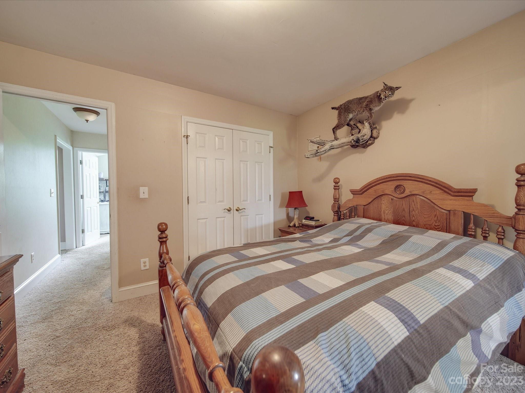 5817 Unionville Road Monroe, NC 28110 - Photo 40 of 46 a bedroom with a bed and a large mirror