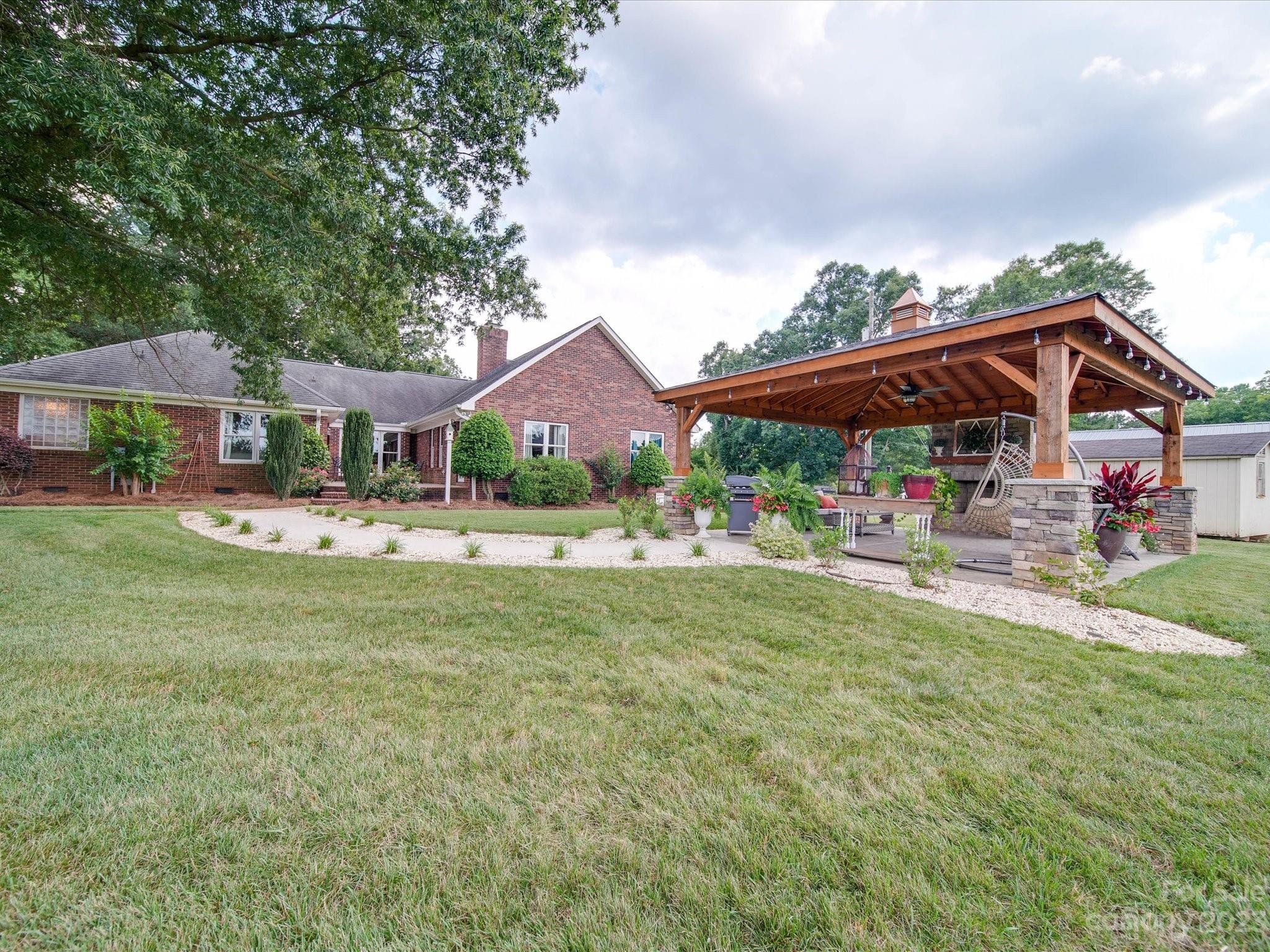 5817 Unionville Road Monroe, NC 28110 - Photo 6 of 46 a view of house with garden and tall trees
