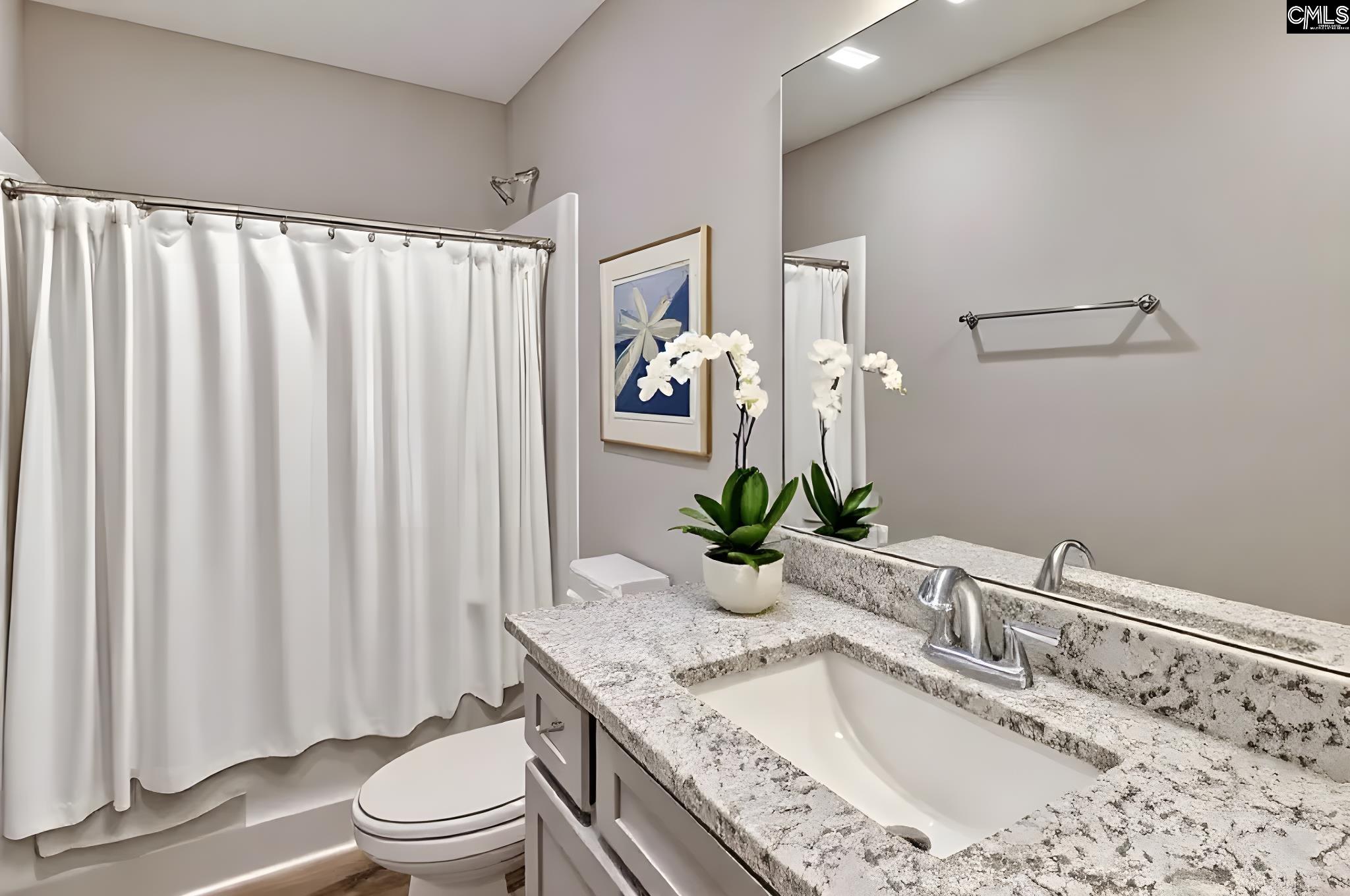 259 Eastover Road Eastover, SC 29044 - Photo 10 of 16 a bathroom with a granite countertop sink a toilet and mirror