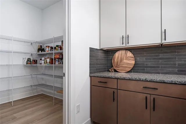 a living room with furniture kitchen and a table