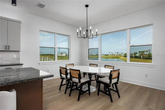 a large kitchen with granite countertop lots of counter space and stainless steel appliances