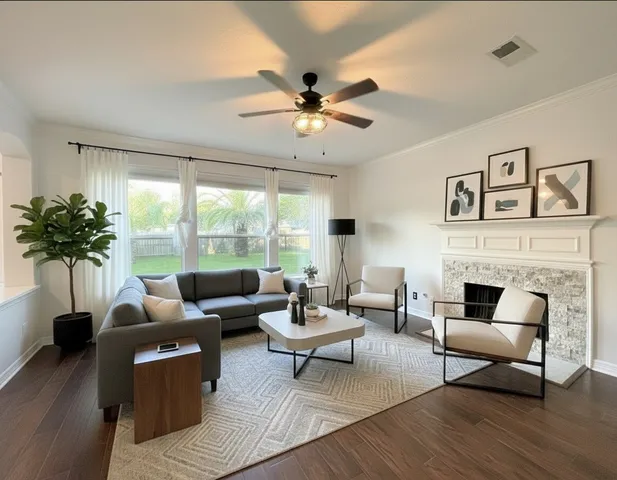 a view of an empty room with wooden floor fireplace and a window