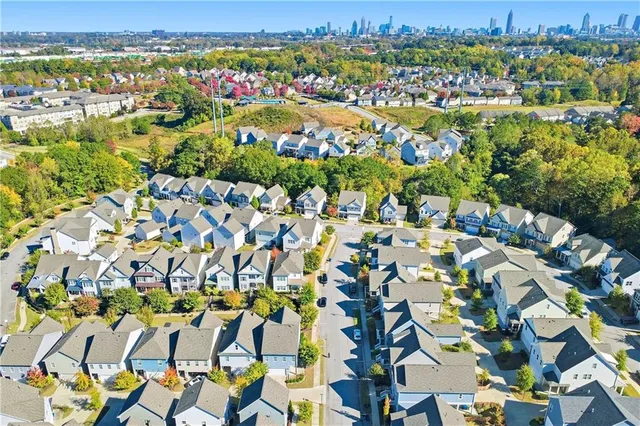 an aerial view of residential houses with outdoor space and street view