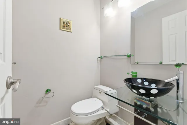 a bathroom with a toilet a sink and a mirror