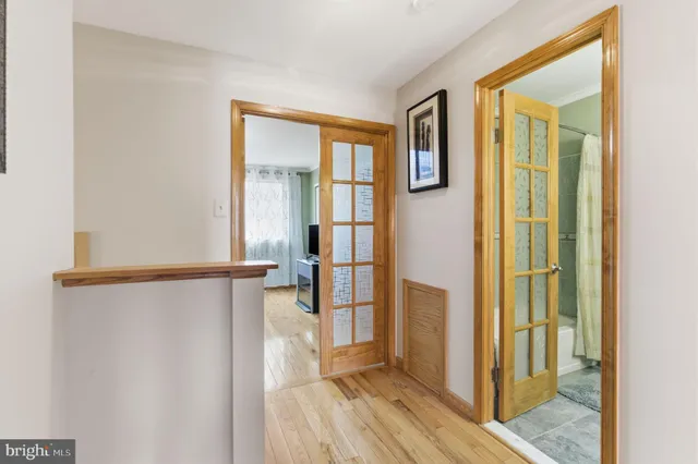 a view of walk in closet with wooden floor