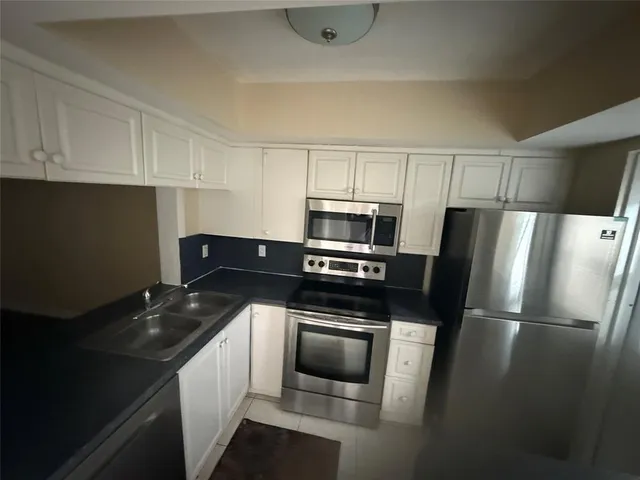 a kitchen with a sink stove and refrigerator