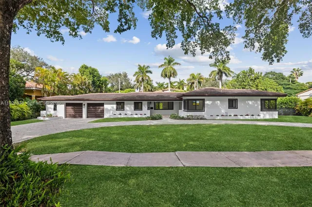 a front view of a house with a garden