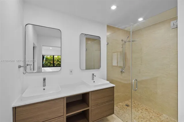 a bathroom with double vanity sink and a mirror