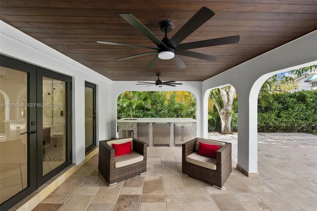 a living room with furniture and a floor to ceiling window