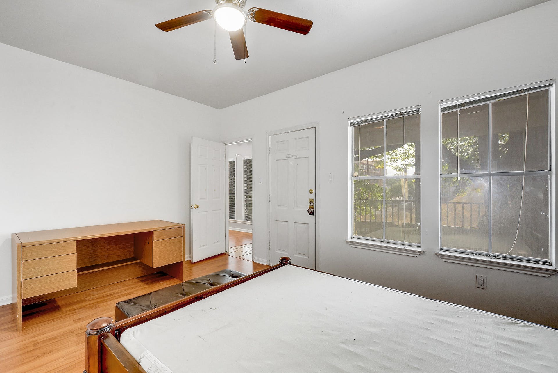 2529 Rio Grande Street, Unit 12 Austin, TX 78705 - Photo 19 of 25 a bedroom with a bed and wooden floor