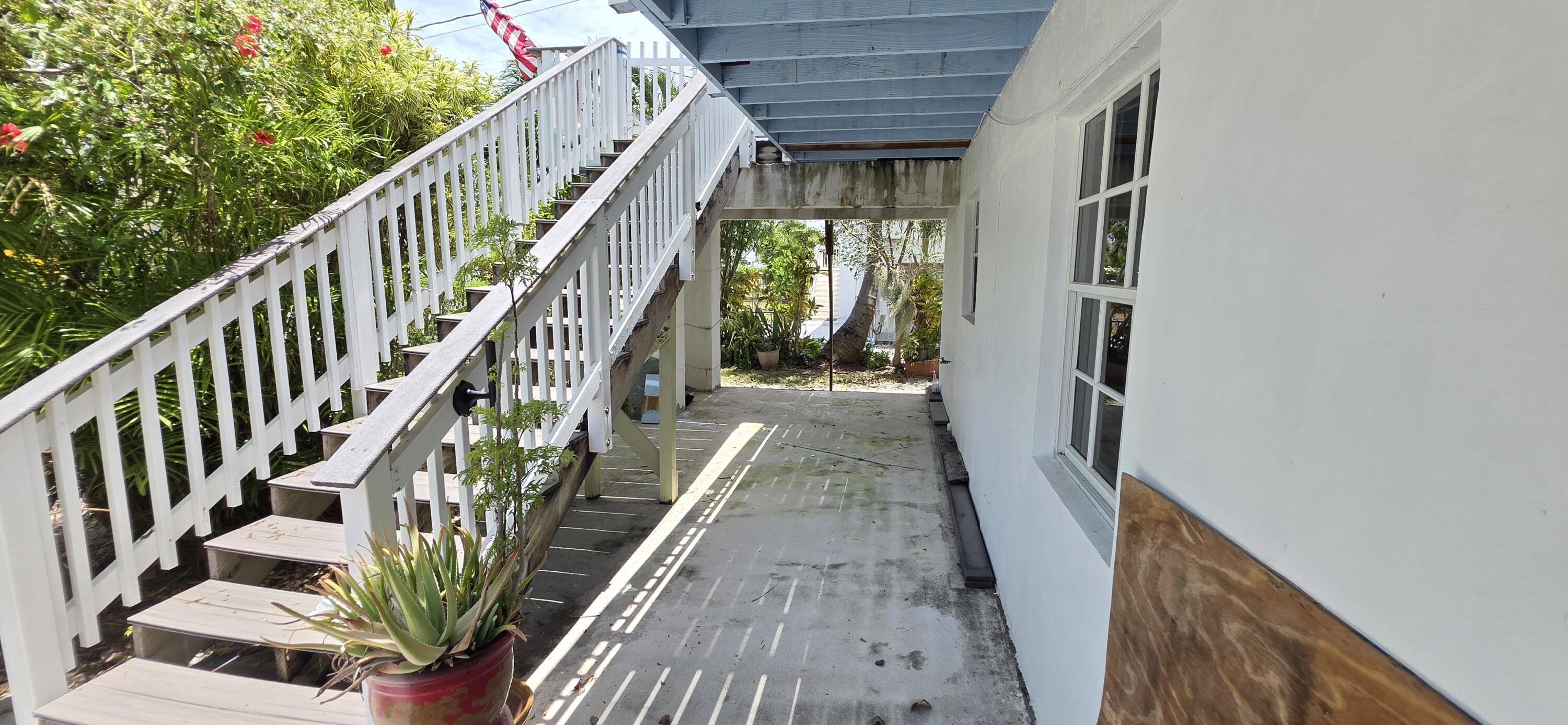 8 Emerald Drive Key West, FL 33040 - Photo 24 of 43 a view of stairs and hall with wooden floor