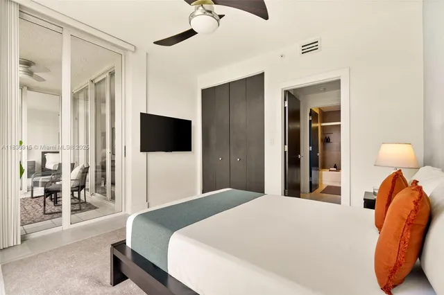 a bedroom with a bed and a flat tv screen