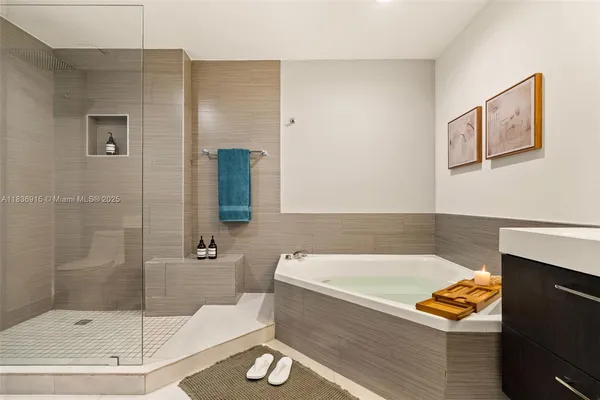 a bathroom with a tub and a shower