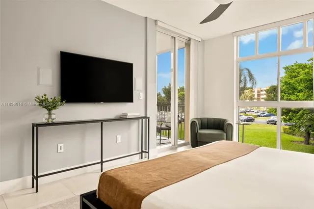 a bedroom with a bed and a flat tv screen