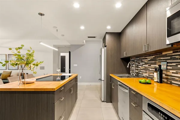 a kitchen with stainless steel appliances a sink a stove and a refrigerator