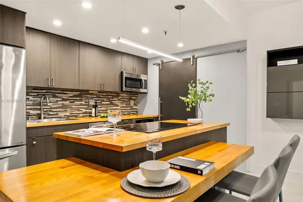 a dining room with furniture and a wooden floor