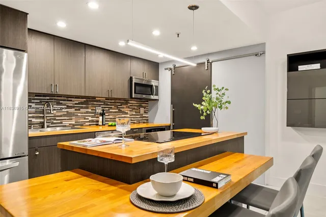 a dining room with furniture and a wooden floor