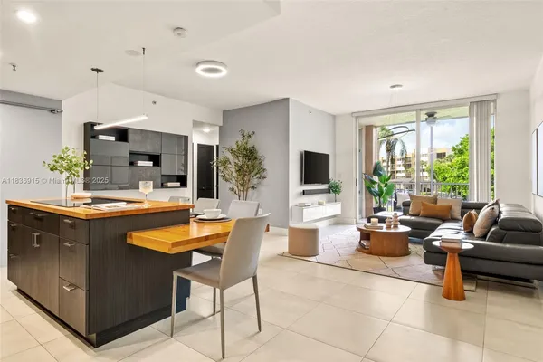 a living room with fireplace furniture and a large window