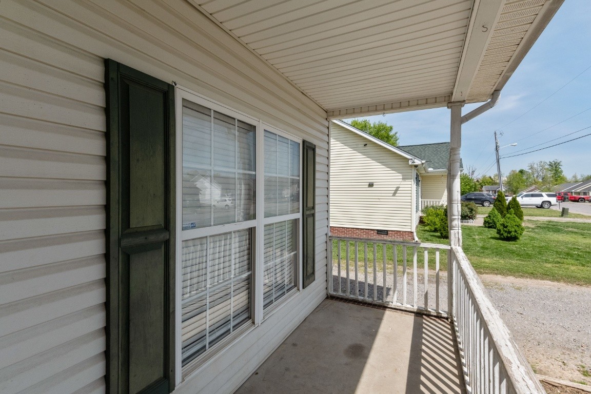 323 Bandera Lane Springfield, TN 37172 - Photo 3 of 33 a porch with a table and chairs