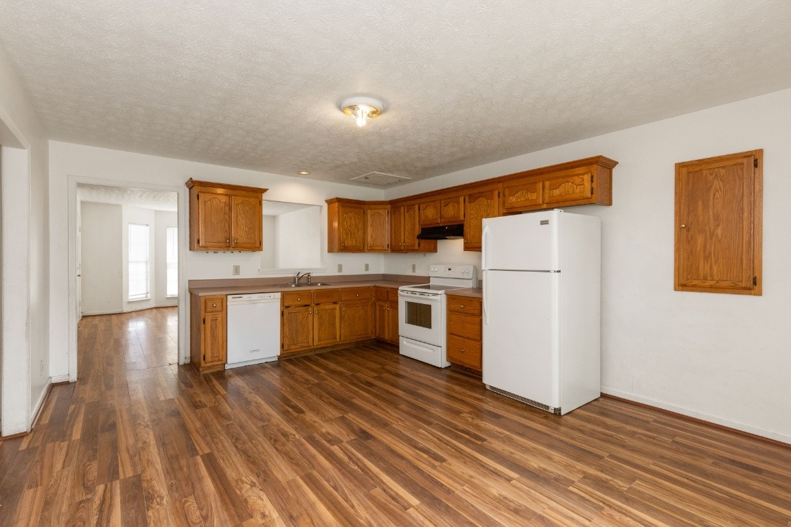 323 Bandera Lane Springfield, TN 37172 - Photo 8 of 33 a kitchen with a refrigerator a stove top oven a sink and dishwasher with wooden floor