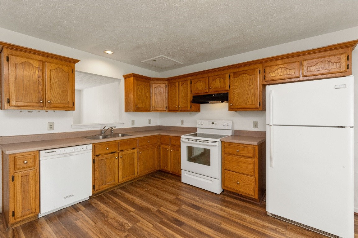 323 Bandera Lane Springfield, TN 37172 - Photo 9 of 33 a kitchen with granite countertop white cabinets and white appliances