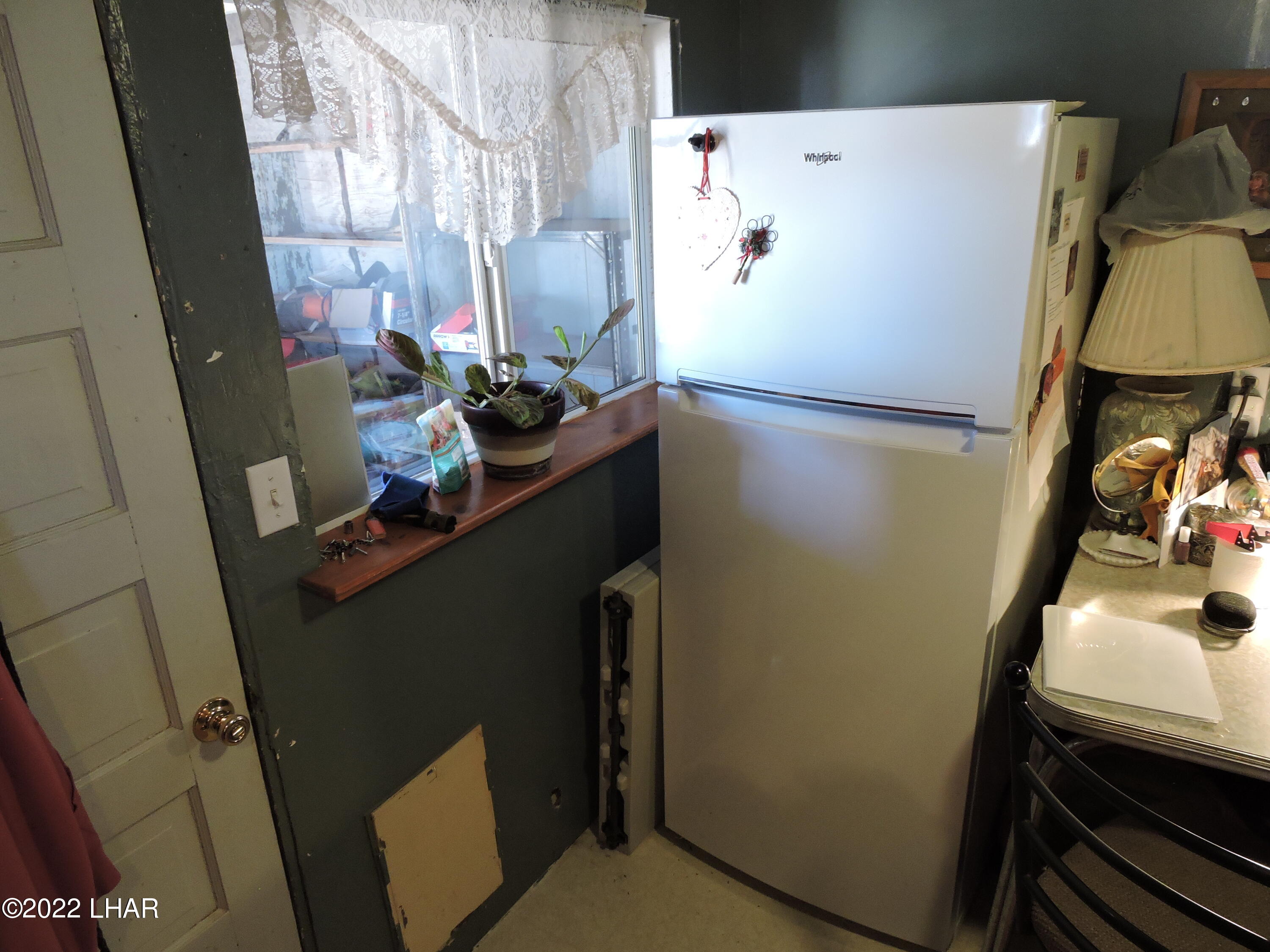 1566 South Elfrida Road Golden Valley, AZ 86413 - Photo 44 of 45 a white refrigerator freezer sitting inside of a kitchen