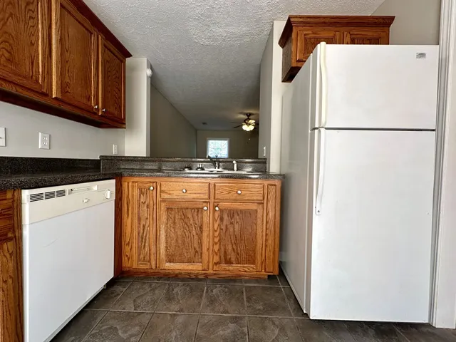 a kitchen with a refrigerator and a stove