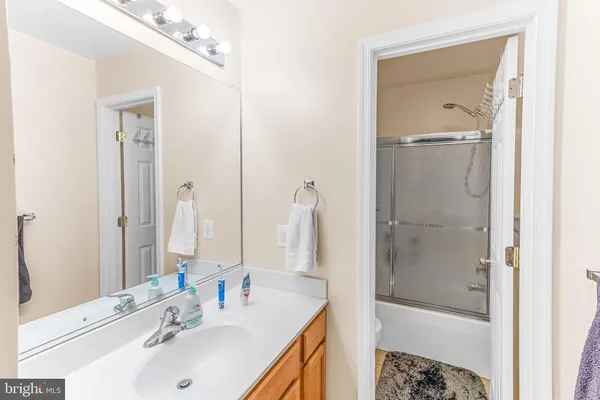 a bathroom with a sink a mirror and a shower