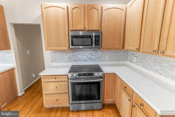 a kitchen with granite countertop a stove and a refrigerator
