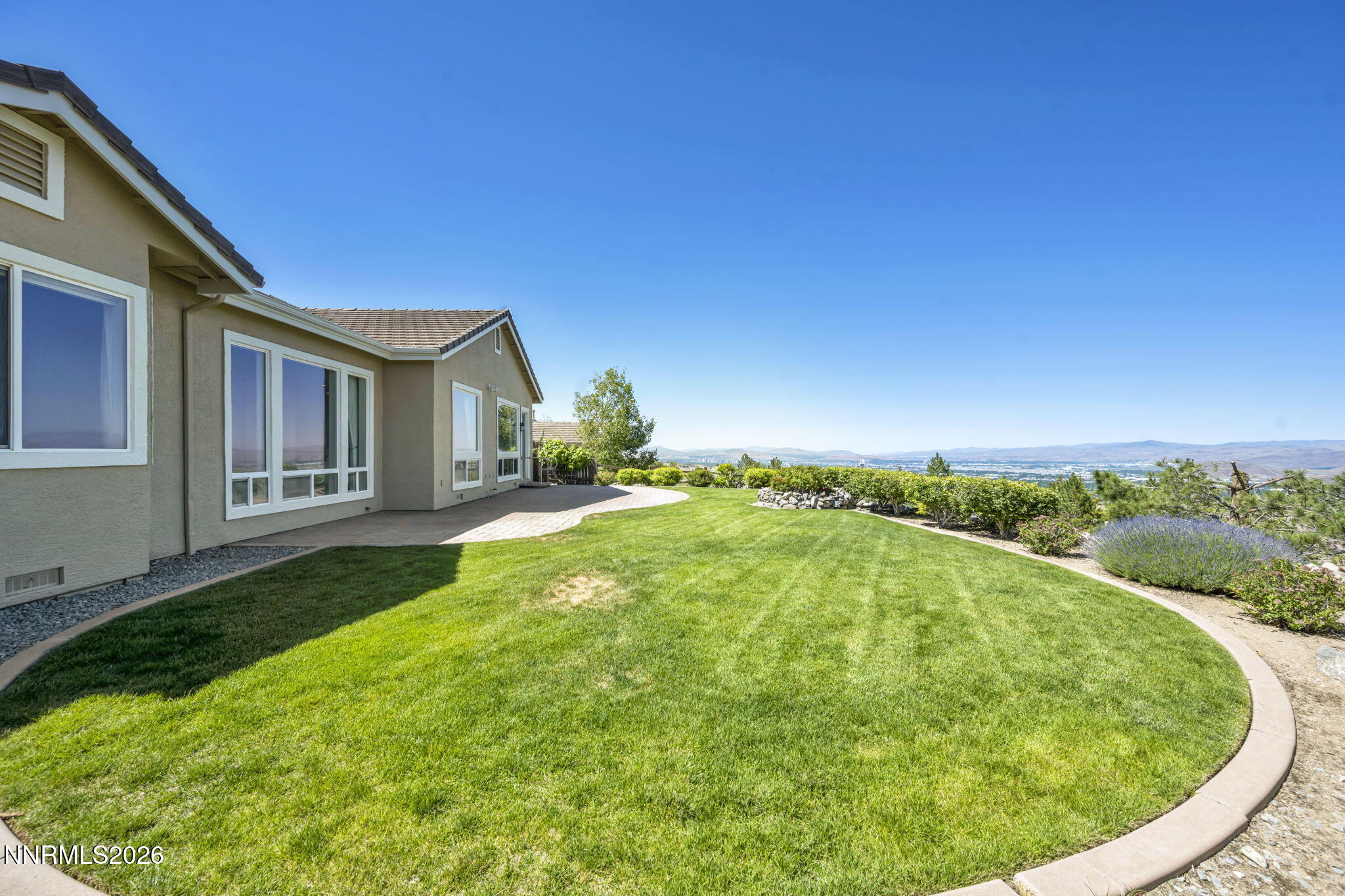 574 Echo Ridge Court Reno, NV 89511 - Photo 11 of 58 a view of an house with backyard outdoor space and garden