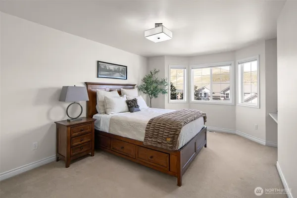 a spacious bedroom with a bed and window