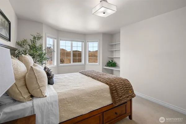 a bedroom with a bed and a window