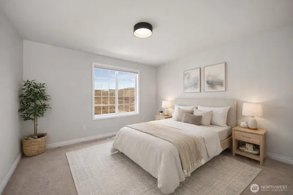 a bedroom with a bed and a potted plant