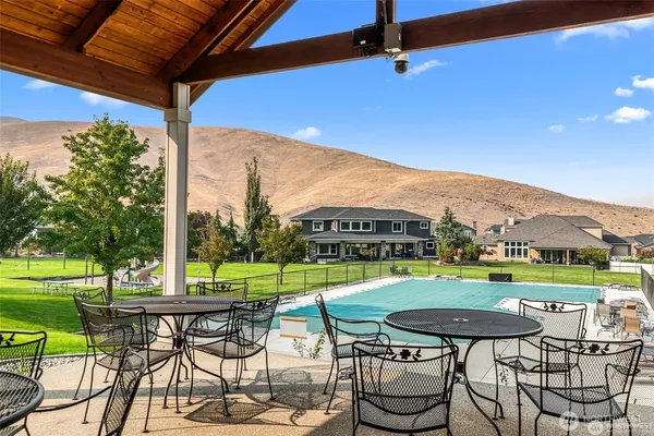 a view of an chairs and table in patio with a yard