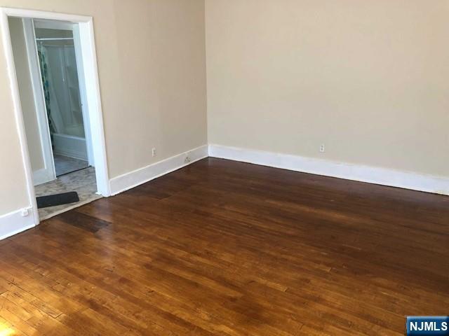 82 Park Avenue, Unit 1 Rutherford, NJ 07070 - Photo 3 of 6 an empty room with wooden floor