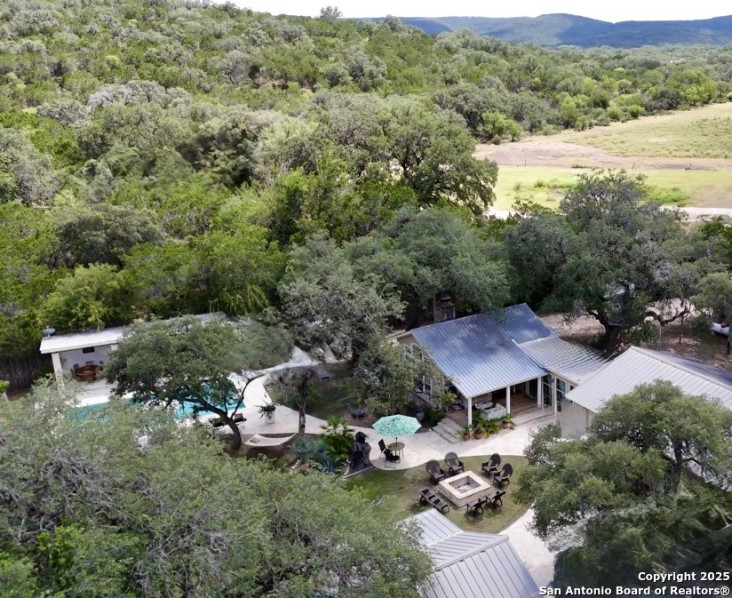 512 County Road 348 Concan, TX 78838 - Photo 2 of 39 an aerial view of a house with garden view and mountains