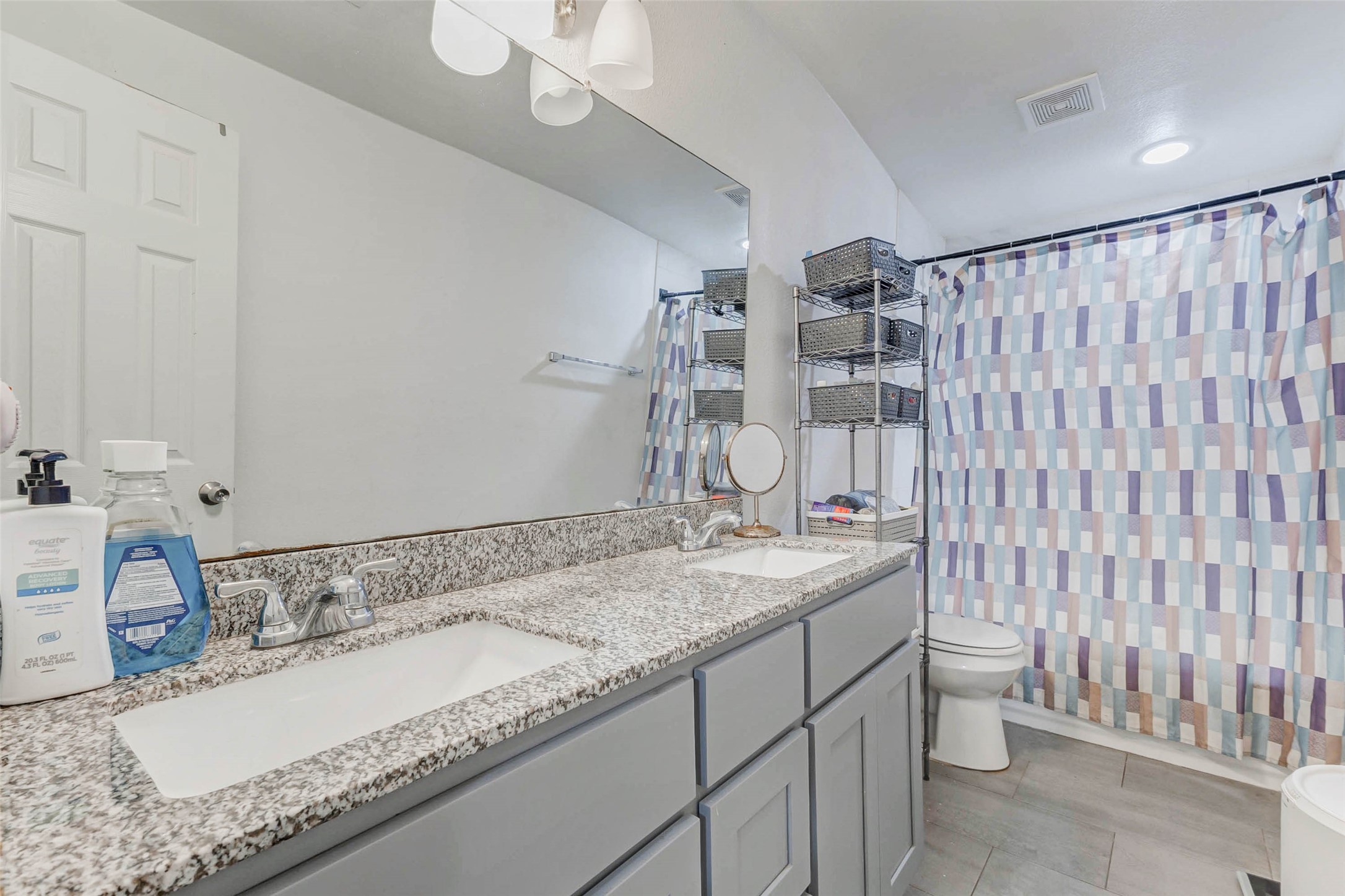 907 Whitaker Avenue Pasadena, TX 77506 - Photo 15 of 35 a bathroom with a granite countertop sink and a mirror