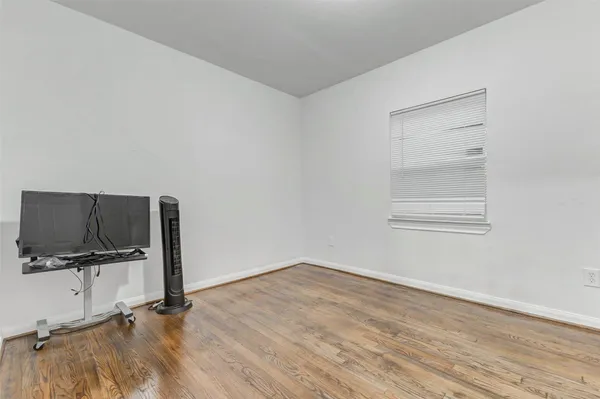 a view of a room with wooden floor and cabinet