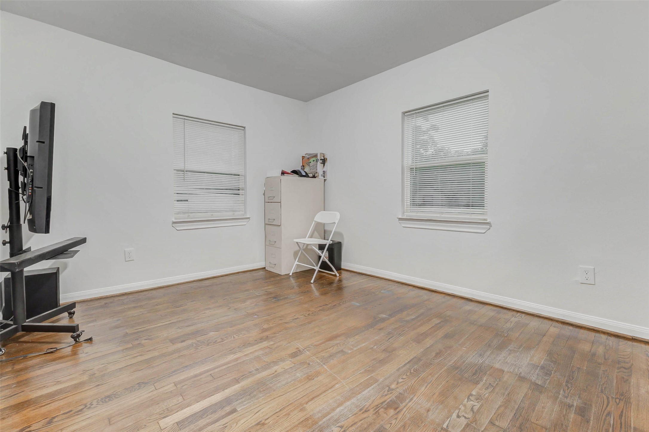 907 Whitaker Avenue Pasadena, TX 77506 - Photo 22 of 35 a view of empty room with wooden floor and fan