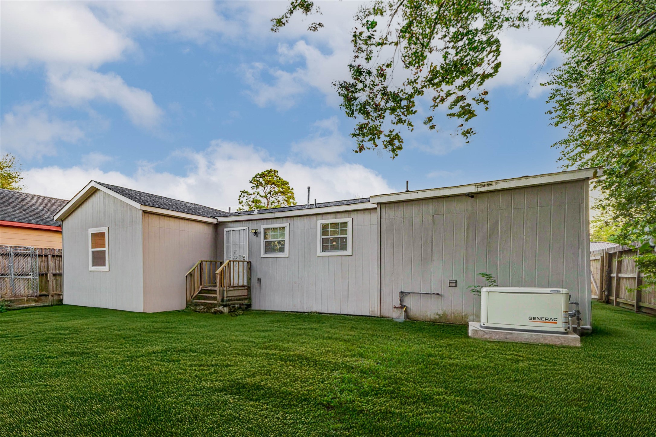 907 Whitaker Avenue Pasadena, TX 77506 - Photo 26 of 35 a view of a backyard with potted plants and a large tree