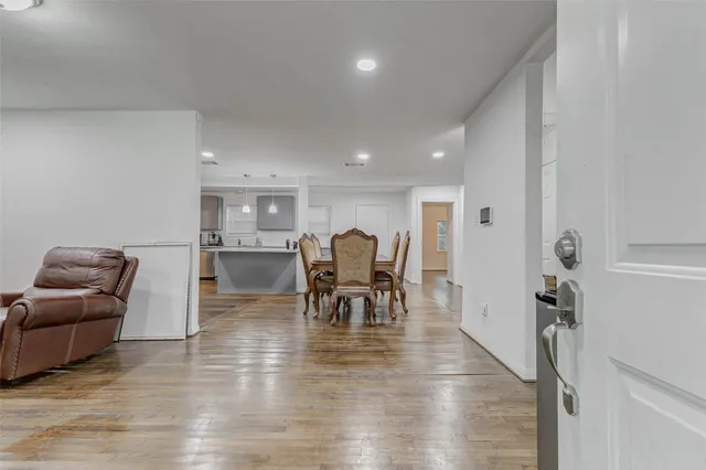 a living room with furniture and a dining table with kitchen view