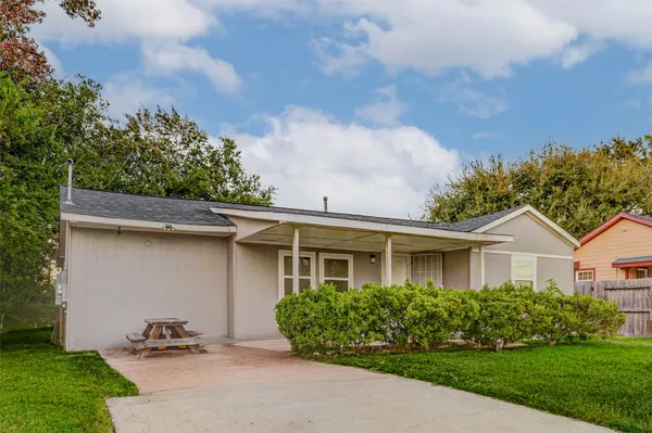 a backyard of a house with table and chairs