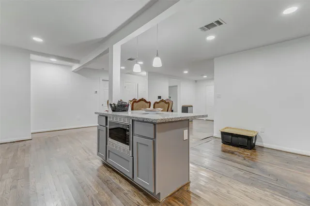 a stove top oven sitting inside of a kitchen