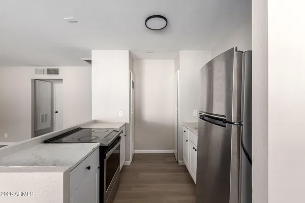 a kitchen with a refrigerator and a sink
