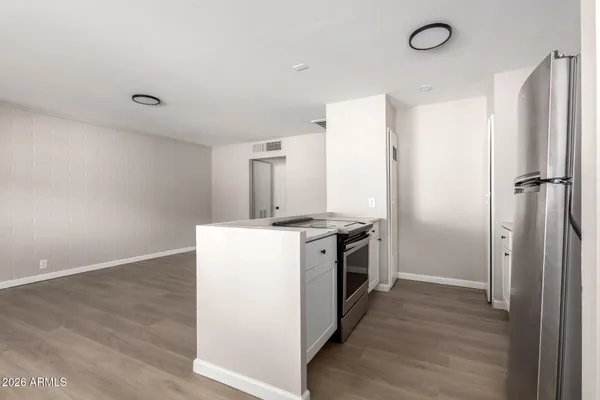 a view of a kitchen with a stove wooden floor and staircase