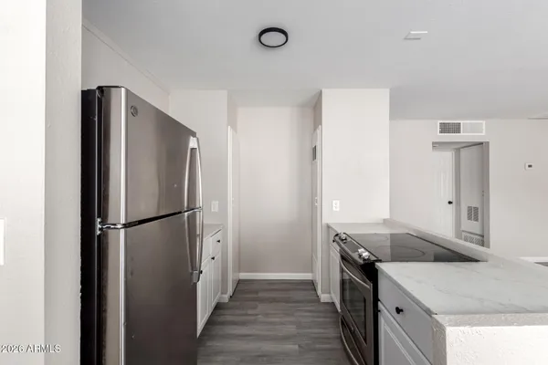 a kitchen with a refrigerator and a sink