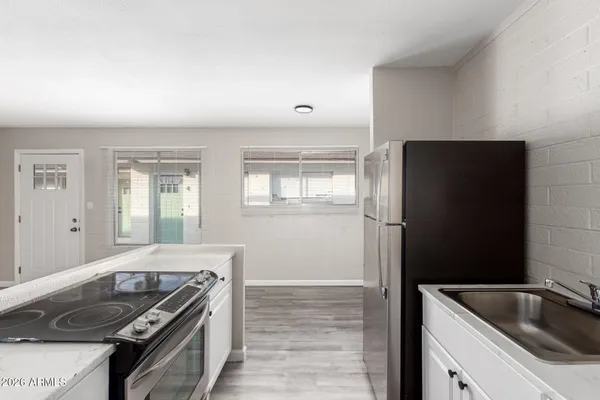 a kitchen that has a sink and a stove
