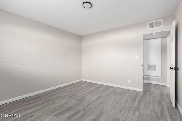 a view of an empty room with wooden floor