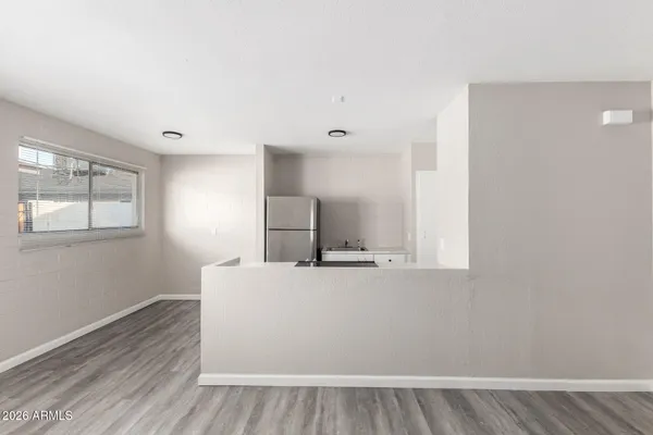 a view of a kitchen with wooden floor and electronic appliances